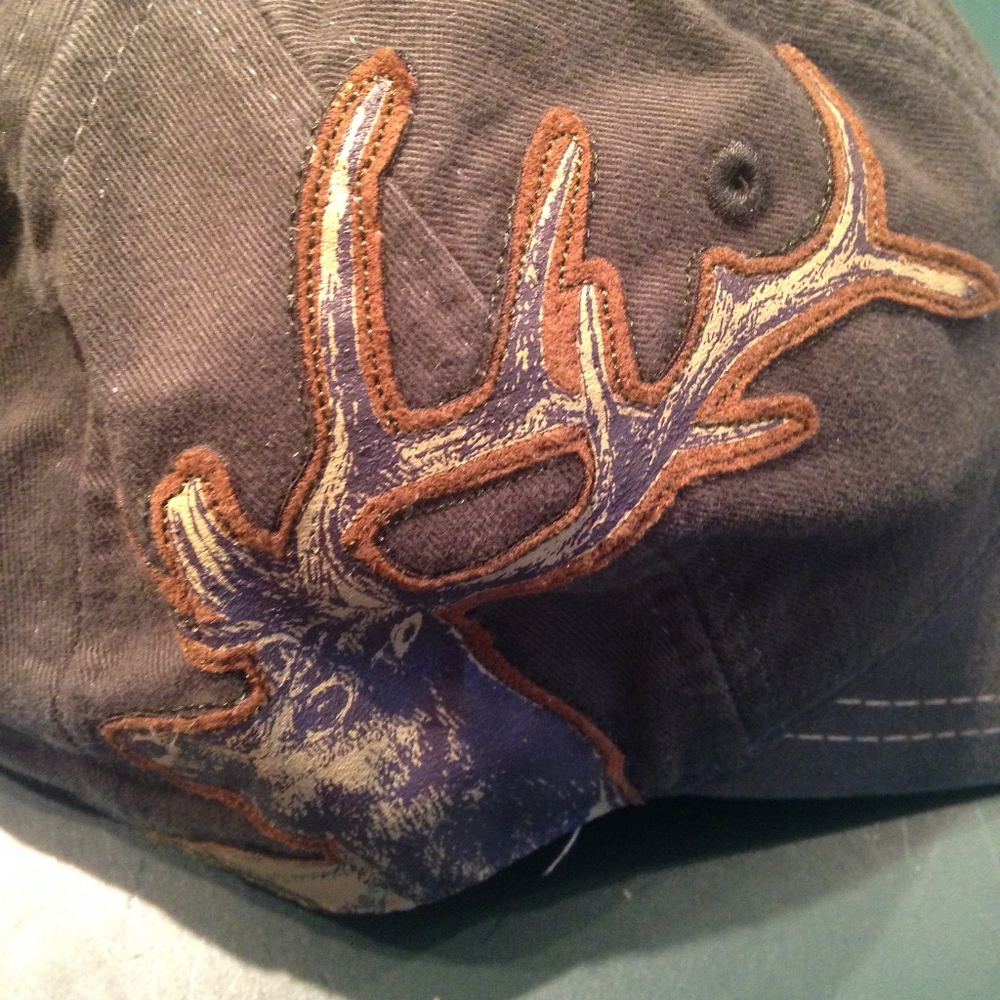 Elk stitched onto a green hat